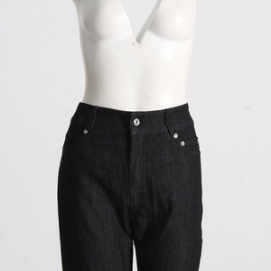 Close-up of black denim jeans featuring high waist design and metal button closure