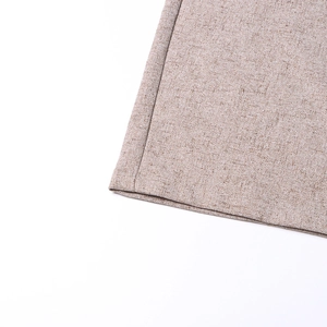 Close-up of high-waist trousers showing oatmeal linen fabric texture and stitching detail