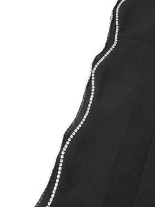 Detail of elegant black suit jacket sleeve featuring double rows of sparkling rhinestones