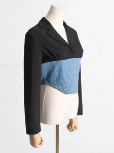 Fashionable black blazer mixed with denim corset waist on a 45-degree angle studio mannequin