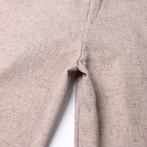 Macro shot of high-waisted wide leg trousers with textured linen blend fabric seams