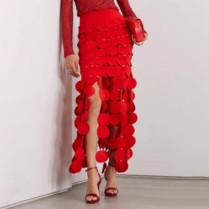 Detailed close-up of red hollowed-out polka dot layered skirt with fringe hem and elegant style