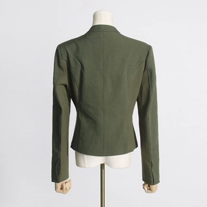 Detail view of the back seams and slim waist design of a deep green blazer jacket