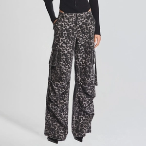Detail of cargo pockets and leopard print pattern on high-waist denim pants for women