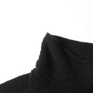 Close-up of black ribbed knit turtleneck showing soft fabric texture and stitching