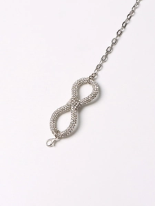 Detail of silver infinity pendant necklace with pavé crystal accents and lobster clasp