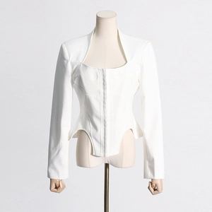 Detail of white structured blazer with boned waist, square neckline and curved hemline