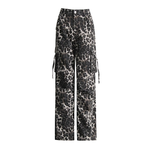 Close-up of leopard print cargo pants featuring side flap pockets and metal buckle straps