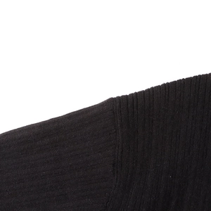 Detail of black ribbed knit fabric showing the seam quality and vertical texture