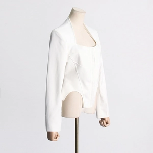 Detailed close-up of white slim-fit top with boned waist and square neckline design