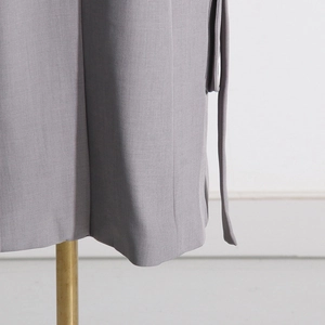 Detail des grauen Blazers mit Fransensaum und seitlichem Kordelzug auf Webstoff