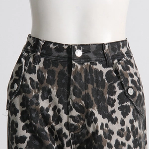Close-up of leopard print cargo pants featuring metal button fly and utility side pockets