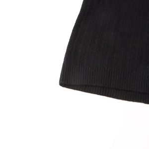 Detailed macro view of black ribbed knit texture on long sleeve sweater cuffs