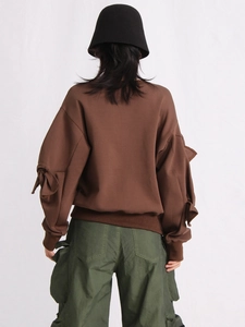 Brown crewneck sweatshirt with bow ribbon sleeves and olive cargo pants for women