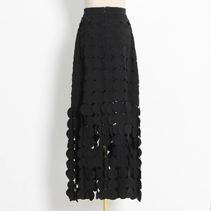 Detail of black high-waisted midi skirt with unique laser-cut hollow dot layered design