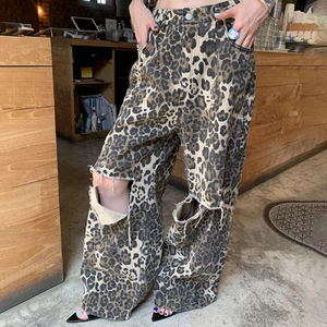 Detailed view of high-waist leopard print wide-leg jeans with distressed knee cutouts