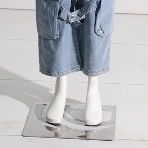 Detailed view of cargo jeans featuring oversized utility pockets and matching denim belt