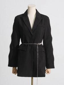 Fashionable black blazer featuring cutout rhinestone sleeves and a pearl chain belt