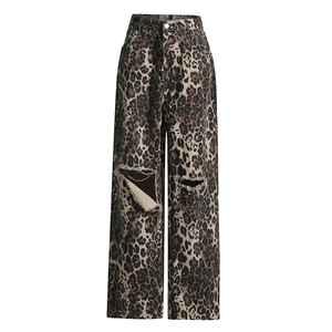 Detail of high-waisted leopard print wide-leg trousers with distressed knee rips