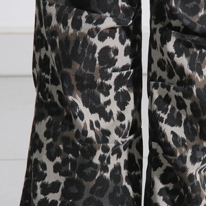 Detailed macro view of twill cotton leopard print fabric on multi-pocket cargo pants