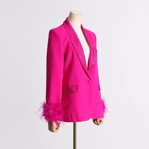 Detail of rose red blazer featuring rhinestone lapels and ostrich feather cuffs