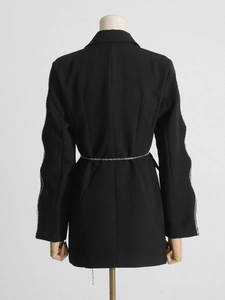 Black blazer with rhinestone-trimmed sleeves and delicate metal chain belt, back view