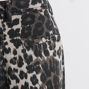 Close-up of leopard print cargo pants showing detailed twill fabric and back pocket