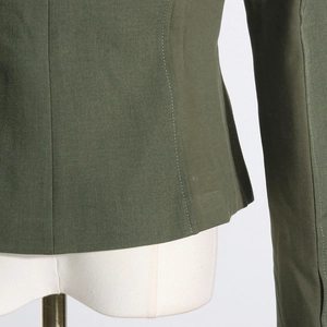 Detail of army green blazer showing fabric texture and neat double-needle stitching
