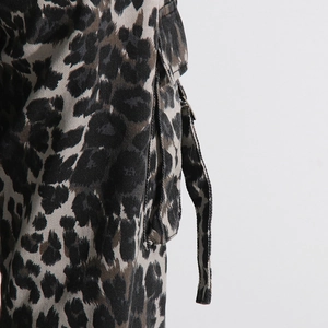 Close-up of leopard print cargo pants featuring side pockets and durable cotton fabric