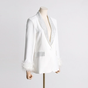 Detail of white blazer featuring rhinestone lapels and ostrich feather cuffs for women