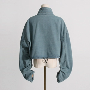 Back view of light blue denim jacket with cropped hem, drawstring and pleated sleeves