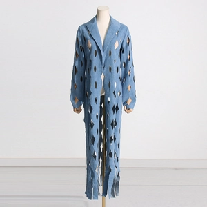 Close-up of diamond cutout denim trench coat with fringe hem and light blue finish