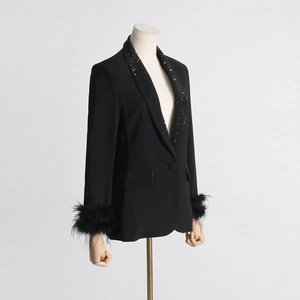 Detail view of rhinestone collar and ostrich feather cuffs on black blazer jacket