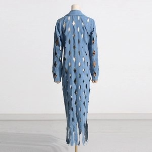 Detail of light blue denim coat with diamond cut-outs and fringe hem on the back