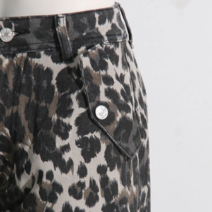 Detailed close-up of leopard print cargo jeans with flap pockets and metal buttons