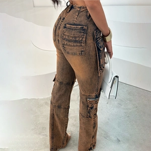 Detail of cargo pockets and metal zipper on vintage washed brown denim pants