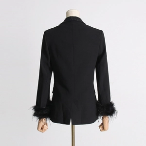 Back view of black blazer featuring ostrich feather cuffs and rhinestone collar detail