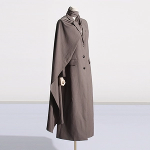 Detail view of deep brown long trench coat featuring a matching stylish scarf shawl design
