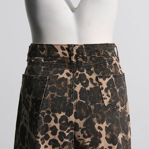 Detail view of high-waist leopard print denim pants showing back pockets and belt loops