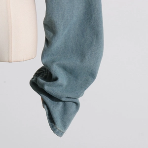 Detailed macro view of elasticated ruched cuffs on a light blue wash denim jacket sleeve