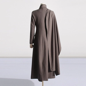 Detailed back view of long tan blazer featuring a unique asymmetrical draped shawl design