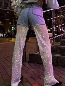 High waist denim shorts with sparkling rhinestone fishnet patchwork in a street style look