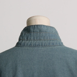 Detail of the stitching and classic blue denim collar on a trendy utility jacket
