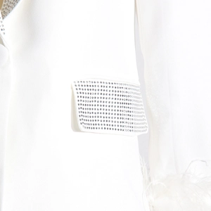 Detail of white blazer with rhinestone collar and ostrich feather cuffs trim decoration