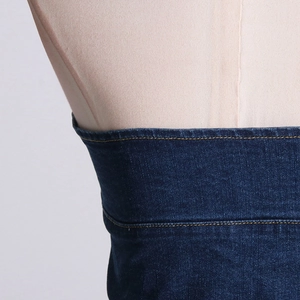 Close-up of slim denim tube top with yellow contrast stitching and premium texture