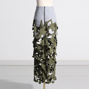 Detail of laser-cut leaf pattern hollow structure on army green patchwork maxi skirt
