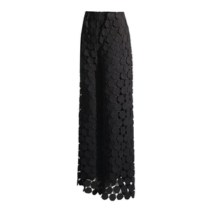 Detailed view of women's black high-waisted wide-leg trousers with hexagon textured embroidery