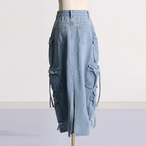 Detail view of washed light blue denim cargo skirt with functional side flap pockets
