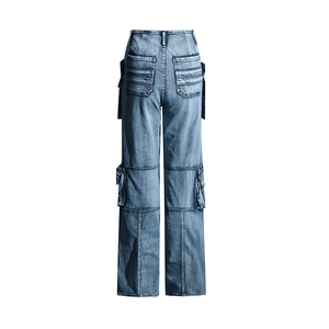 Detailed view of cargo side pockets and washed denim texture on high-waist jeans