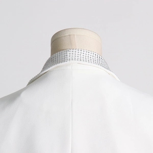 Detailed view of the rhinestone-embellished collar on this elegant white ostrich feather blazer